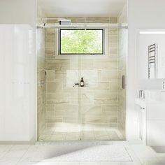 a white bathroom with a window, sink and shower