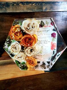 a bouquet of flowers sitting on top of a wooden bench