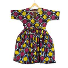 This brightly colored and boldly patterned dress is the original design of Ghana's Lydia Mawuenya Amedzrator. Crafted from 100% cotton in shades of burgundy sky blue and mustard the belted dress features short sleeves a V-neck and full skirt that hits at the knee. Shades Of Burgundy, Knee Length Shorts, Patterned Dress, Full Skirt, Belted Dress, Dress Patterns, Sleeve Cotton, Cotton Shorts, Ghana