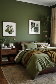 a bedroom with green walls and bedding in the corner, two framed pictures on the wall