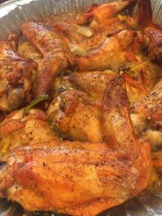 a pan filled with chicken sitting on top of a table