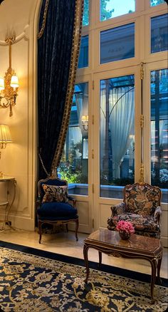 an ornate living room with blue and gold decor