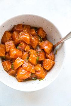 a white bowl filled with food on top of a table