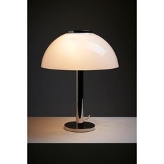 a table lamp with a white shade on it's base and a black base