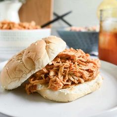 two pulled pork sandwiches on a white plate