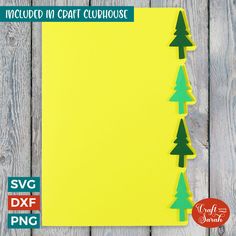 a yellow paper with trees cut out of it on a wooden table next to a clipboard