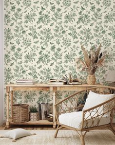 a room with a table, chair and wallpaper in green colors on the walls