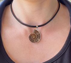 Ammonite Fossil Necklace - Ammonite Necklace - Leather Fossil Necklace - Ammonite Necklace - Ammonite Pendant -  Leather Necklace 1 pc. Ammonite Fossil Necklace, genuine leather ( flat, 4 mm ) Pendant size : 1.5 inch / 4 cm Available lengths for the cord:  14 inch / 35 cm 15 inch / 38 cm 16 inch / 40 cm  17 inch / 43 cm  18 inch / 45 cm Free gift box: You will receive this necklace in a beautiful gift box with cushion inside! Let me pleasantly surprise your loved ones on your behalf if it's a gift! You will receive one necklace of your desired length with a pendant very similar in size, shape, pattern and quality to the ones in photos. If you wish to pick your pendant - please contact me! If you need a special handmade jewelry - something unique or just have a question/comment just contact Ammonite Necklace, Ammonite Pendant, Fossil Necklace, Ammonite Jewelry, Fossil Jewelry, Necklace Leather, Ammonite Fossil, Gold Girl, Funky Jewelry