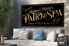 a couch and table in front of a wall with a sign that says patio & spa on it