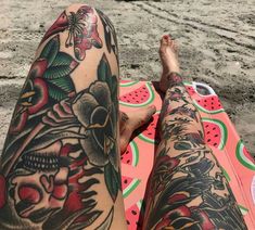 a person laying on top of a beach next to a watermelon covered ground