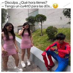 two girls in pink dresses standing next to a man wearing a red spider suit and white shoes