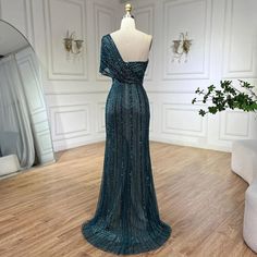 Radiating elegance and allure, this green mermaid evening gown is perfect for upscale wedding affairs in 2024. The mermaid silhouette gracefully accentuates curves, offering a flattering and glamorous fit, while the one-shoulder design adds a touch of sophistication. Featuring a high split, the gown exudes modernity and adds a hint of drama to your look, allowing for graceful movement. Adorned with intricate beadwork, it sparkles with every step, ensuring all eyes are on you as you celebrate in Luxury Embellished One-shoulder Floor-length Dress, Luxury One-shoulder Sequin Evening Dress, Green Hand Embellished Floor-length Gown, Glamorous Green Floor-length Sequin Dress, Green Embellished Floor-length Mermaid Dress, Upscale Wedding, Mermaid High, Graceful Movement, Mermaid Evening Gown