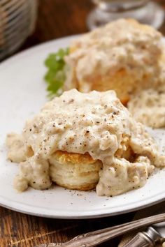 a white plate topped with potatoes covered in gravy