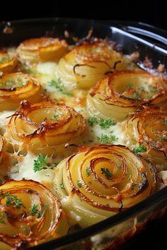 a casserole dish with onions and parsley in the middle, ready to be eaten