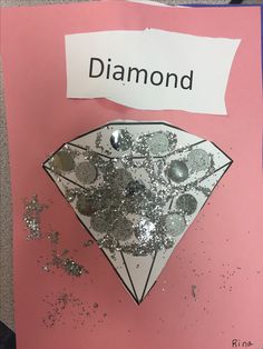 a piece of paper that has been made to look like a diamond on top of it