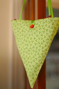 a green triangle hanging from a wooden pole