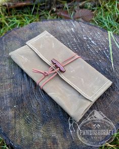 a small notebook sitting on top of a tree stump