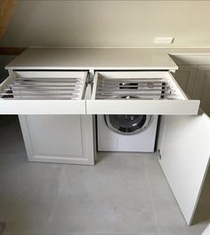 an appliance that is open to show the front door and side shelves for washing machines