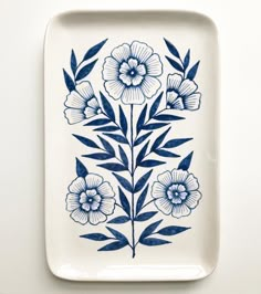 a blue and white plate with flowers on it