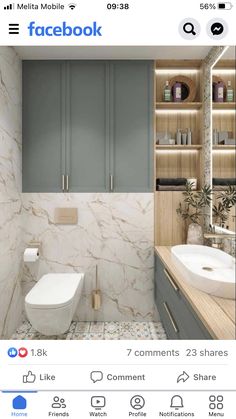 a bathroom with blue cabinets and marble flooring, including a white toilet in the center