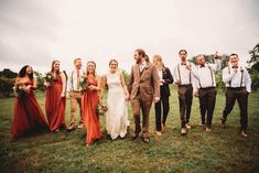 a group of people standing next to each other on top of a lush green field