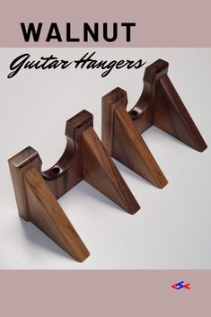 three pieces of wood with the words walnut guitar hangers written below them on a white background