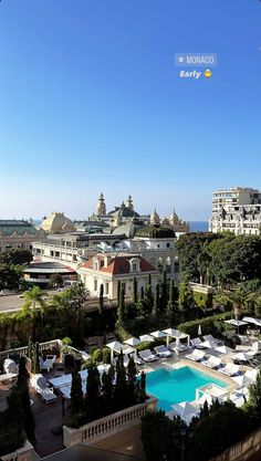 an aerial view of the pool and surrounding buildings with blue skies in the sky above