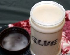 a close up of a cup on a table with a spoon and napkin in the background