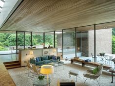 a living room filled with furniture and lots of windows