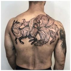 the back of a man's upper body with roosters on it