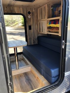 the inside of a camper van with its bed pulled up to it's side