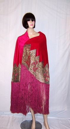 This is a most magnificent cerise-colored shawl with metallic lace embellishments, appliques, and silk fringe, dating to the Art Deco period. The shawl measures 69 across by 36 in length, excluding the 20 of silk fringe. The metallic lace has been embellished with a series of cerise-colored appliques. The shawl is in excellent vintage condition and would make the perfect accessory for any confident woman not afraid of calling attention to herself. 1920 Style, 1920 Dress, Crochet Lace Shorts, 1920's Fashion, 1920 Fashion, Velvet Shawl, Vintage Coats, Lace Shawl, Metal Lace