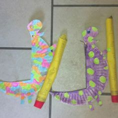 two paper mache lizards and a pencil on the floor