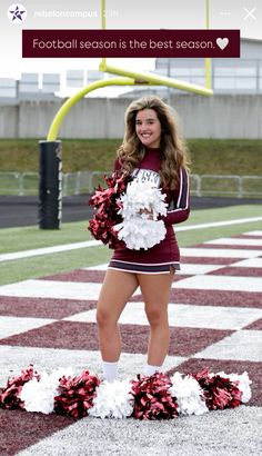 a cheerleader standing on the sidelines with pom poms