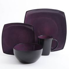 a purple dinnerware set with two black cups and one white bowl on the side