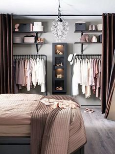 a bedroom with a bed, closet and chandelier hanging from it's ceiling