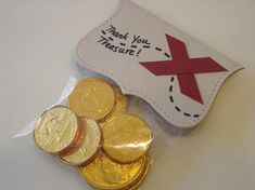 some gold coins in a plastic bag with a thank you message on the front and back