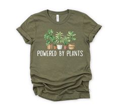 Powered by Plants Shirt, Gardening Shirt, Plant Lover Shirt, Vegetarian Shirt, Gift for Gardener, Retro Plants Shirt, Gardening Tshirt How to order: 1. Select your t-shirt size. 2. Choose your favorite t-shirt color(s). 3. Select quantity from the drop-down menu. 4. Add item(s) to your cart. 5. Choose your payment method. 6. Place your order. Unisex T-Shirt: * 100% cotton (heather colors have polyester) * Fabric weight: 4.5 oz/y² (153 g/m²) * Pre-shrunk for extra durability * Shoulder-to-shoulder placement * Quarter-turned to avoid crease down the center Size:  * We have S to 3XL sizes available (Size chart in Photos) * This is a Unixes T-shirt (compatible for men and women) Wash/Care Instruction: * Turn inside out. * Machine cold wash. * Do not bleach/dry clean. * Do not iron directly on Spring Green Tops With Plant Details, Green Relaxed Fit Shirt With Plant Print, Relaxed Fit Green Shirt With Plant Print, Green Shirt With Plants Print And Relaxed Fit, Green Shirt With Plant Print And Relaxed Fit, Green Tops With Plant Print For Gardening, Green Relaxed Fit T-shirt With Plant Detail, Green Plant Print Tops For Gardening, Green T-shirt With Plant Print For Gardening