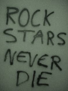 the words rock stars never die written in black ink