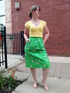 Vintage kelly green cotton skirt with white daisy print. This skirt is so comfortable and it has pockets! Made by Malia of Hawaii and in very good vintage condition. Skirt has a one white button and zip closure in the back. Measurements: Waist 30" Length 26.5" Retro Green Bottoms For Day Out, Green Skirt With Pockets For Day Out, Retro Cotton Skirt For Day Out, Green Cotton Skirt For Day Out, Retro Skirt With Pockets For Spring, Retro Spring Skirt With Pockets, Green Retro Skirt For Summer, Green Gathered Skirt For Day Out, Retro Green Skirt For Summer