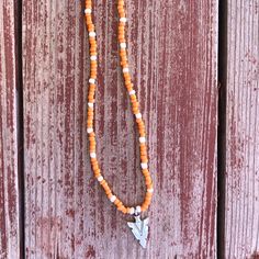 Orange & White Seed Bead Necklace With Arrowhead Charm White Bohemian Beaded Necklaces For Spring, Southwestern Style Orange Beaded Necklace, Western Glass Bead Necklace, Orange Beaded Southwestern Necklace, White Seed Bead Necklace, Turquoise Arrowhead Necklace, Rustic Handmade Arrowhead Necklace, Bead Necklaces, Ring Ideas