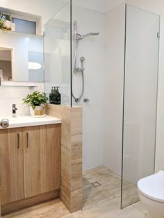 a bathroom with a sink, toilet and shower stall in it's own area