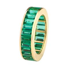 18 Karat Yellow Gold 5.39 Carat Baguette-Cut Natural Emerald Eternity Band Ring This beautiful vibrant green emerald band is a class apart. The buyer’s choice as it stands for an astoundingly perfect cut of baguette-cut emeralds embellished in the enclosed solid yellow gold bezel setting. Its uniqueness comes from the ideal emerald cuts that are identically matched to make it all the more graceful and elegant. It brings out the elemental look of class and simplicity making it a timeless ring for Formal Green Gemstone Eternity Band, Green Emerald Eternity Band With Emerald Cut, Green Emerald Cut Emerald Eternity Band, Luxury Green Emerald Ring With Baguette Diamonds, Luxury Green Rings With Baguette Diamonds, Luxury Green Channel Set Rings, Green Emerald Ring With Baguette Cut, Luxury Green Baguette Cut Emerald Ring, Baguette Cut Green Emerald Ring