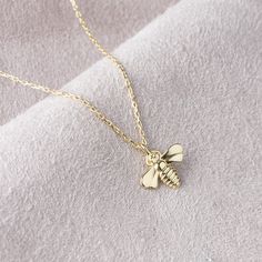 "10k 14k 18k Solid Gold Bee Necklace, Gold Bee Pendant, Animal Necklace, Bee Charm, Christmas Gift, Valentines Day Gift, Mothers Day Gift Our product weighs 1.49 gr and the chain length is 42 cm. All of our products has the stamp \"585\" on them. (which states that this is real gold) Your products will be shipped with free shipping UPS express within 1-3 business days. There may be +/- 0.15 change in gram information due to production. Your products will be shipped with free shipping UPS express Dainty Pendant Charm Necklace, Dainty Yellow Gold Charm Necklace With Hallmark, Gold Charm Necklaces As Gift, Fine Jewelry Charm Necklace As Gift, Silver Charm Necklace Stamped 14k As Gift, Gift Silver Charm Necklace Stamped 14k, Dainty 14k Gold Necklace With Hallmark, Gold Jewelry Christmas Gift For Her, Yellow Gold Charm Necklaces With Hallmark For Gifts