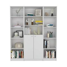 a white bookcase filled with lots of books next to a vase and other items