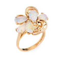 Stylish vintage opal ring (circa 1970s) crafted in 14 karat yellow gold.   Five cabochon cut teardrop shaped opals measure 8mm x 5mm (estimated at 0.50 carats each - 2.50 carats total estimated weight). The opals are in very good condition and free of cracks or crisps.   The opals are set into an open mosaic design. The ring is great for day or evening wear. The opals exhibit a good colour matrix with green, blue, turquoise, yellow and purple colour flashes. The medium rise ring (11mm - 0.43 inc Fine Jewelry 14k Gold Pear-shaped Opal Ring, 14k Gold Pear-shaped Opal Ring Fine Jewelry, Pear-shaped 14k Gold Opal Ring Fine Jewelry, 14k Gold Pear-shaped Opal Ring, Pear-shaped 14k Gold Opal Ring, Elegant Pear-shaped Opal Ring, Elegant 14k Gold Pear-shaped Opal Ring, Fine Jewelry Yellow Gold Pear-shaped Opal Ring, 14k Yellow Gold Pear-shaped Opal Ring