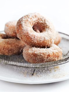 some sugared donuts are on a plate