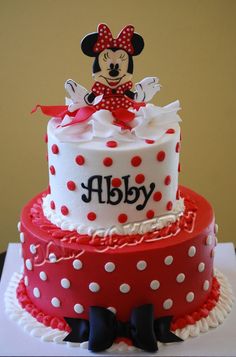 a red and white cake with minnie mouse on top