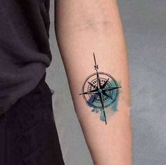 a compass tattoo on the arm