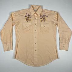 Mustang Western Shirt Snap Button Up Embroidered Orange Long Sleeve Adult 16-33 Nice pearl snap buttons and embroidered leaf accents. Well cared for shirt with plenty of life left. Measurements shown are taken flat and are approximate. To ensure fit, we recommend that you compare our measurements to your favorite garment. All of our items are clean, carefully inspected and we do our best to identify any and all defects. If you are unhappy with an item or it's not the perfect fit, we offer free r Retro Embroidered Cotton Shirt, Classic Long Sleeve Embroidered Shirt, Vintage Embroidered Button-up Shirt, Classic Cotton Shirt With Floral Embroidery, Classic Cotton Tops With Floral Embroidery, Embroidered Orange, Embroidered Leaf, Embroidered Leaves, Orange Long Sleeve